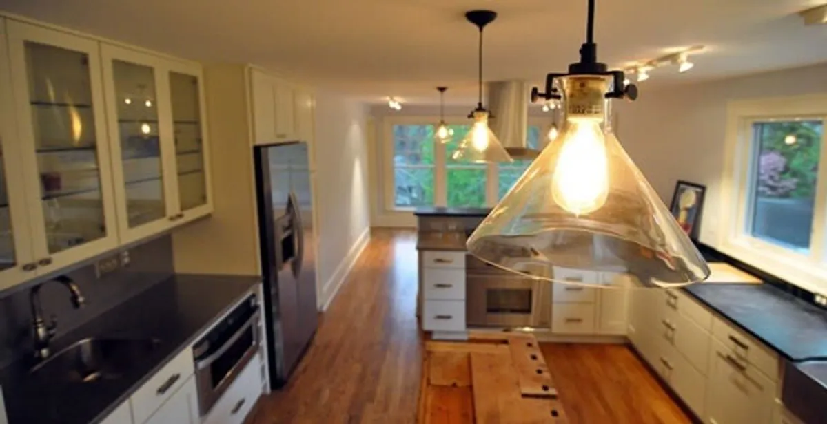Residential electrician installing modern indoor light fixture in a home in Clearwater, FL